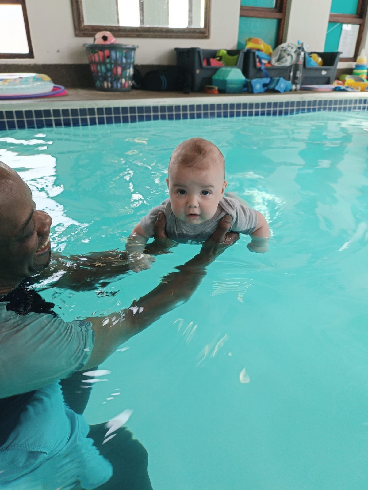 Coach Utche working with a young swimmer